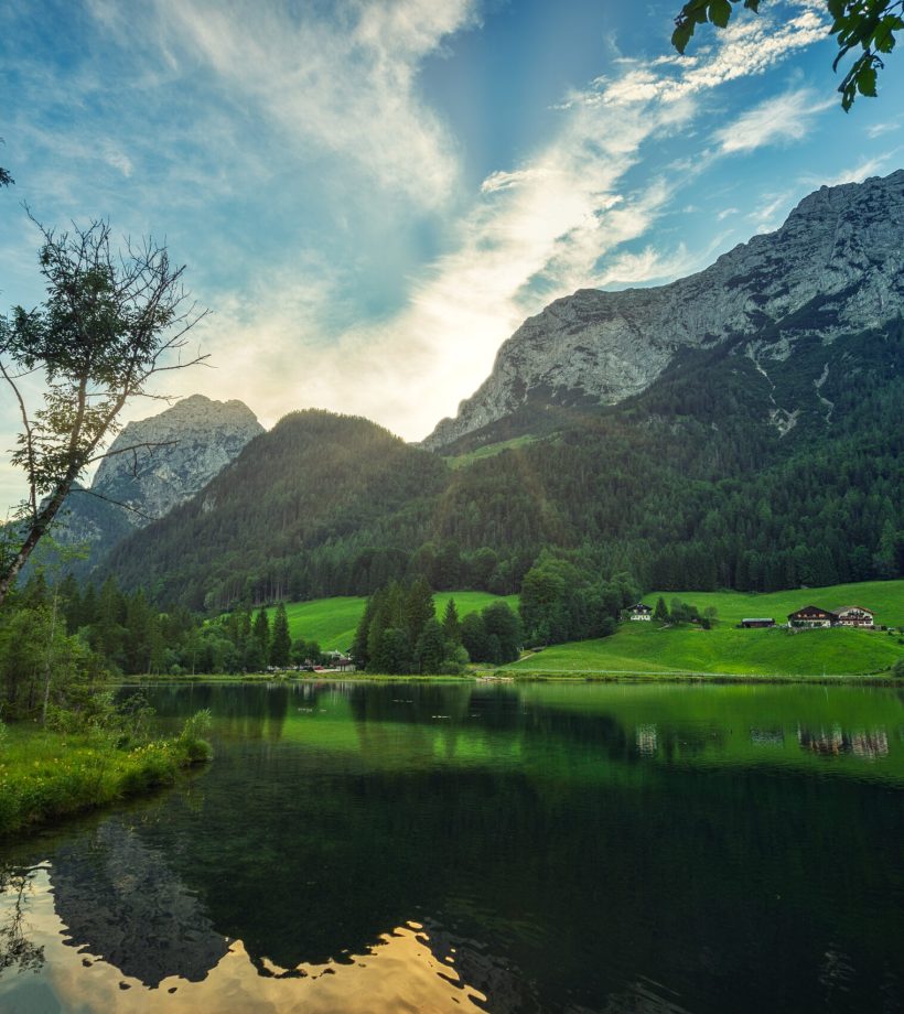green-trees-near-lake-mountain-blue-sky-daytime